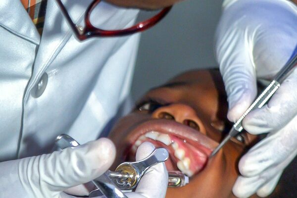 A dentist examining a child's teeth